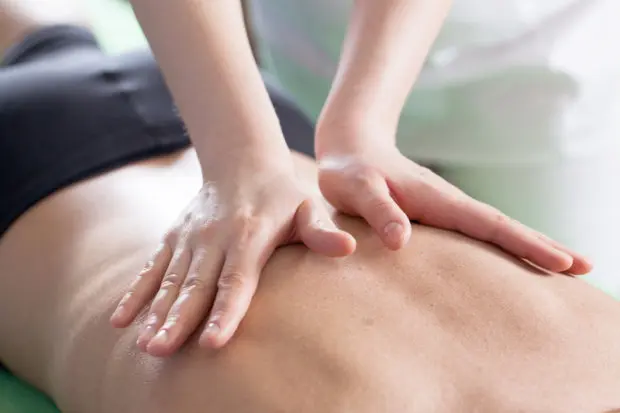 Close-up view of a person receiving a chiropractic adjustment.