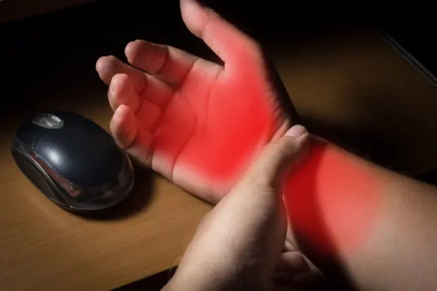 An image of a person's hand. All the areas in pain are highlighted in red.